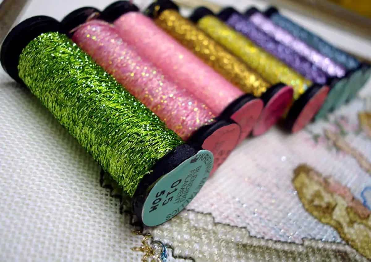 Metallic threads add light and color to needlework designs.